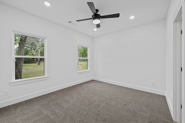 unfurnished room featuring ceiling fan and carpet floors