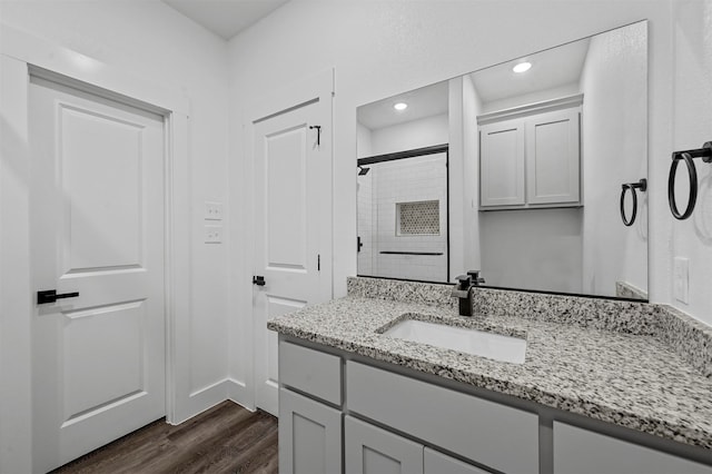 bathroom featuring vanity, hardwood / wood-style flooring, and walk in shower