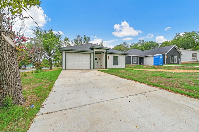 ranch-style home with a garage and a front yard