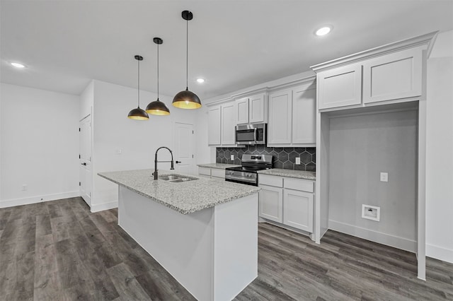 kitchen with white cabinetry, stainless steel appliances, dark hardwood / wood-style flooring, sink, and light stone countertops