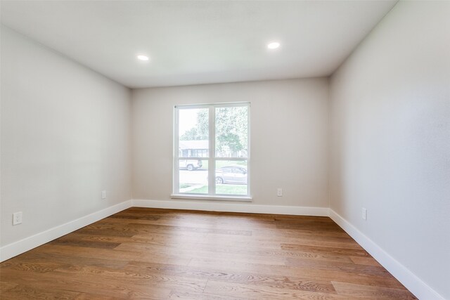 spare room with hardwood / wood-style flooring