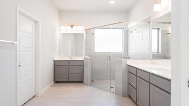 bathroom with vanity, tile patterned floors, and walk in shower