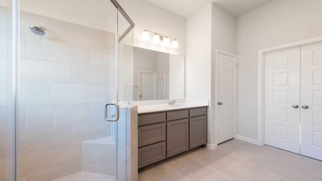 bathroom with vanity, tile patterned floors, and a shower with shower door