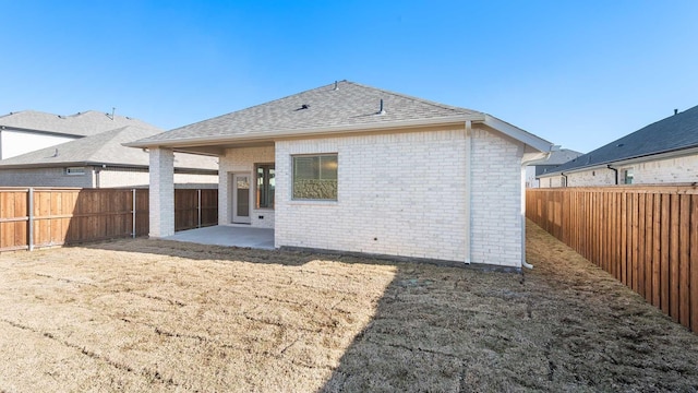 rear view of property featuring a patio area