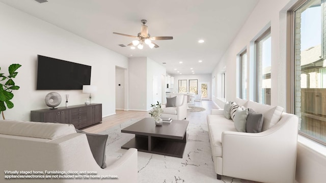 living room featuring ceiling fan and light hardwood / wood-style flooring