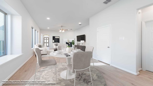 dining space featuring ceiling fan, a healthy amount of sunlight, and light wood-type flooring