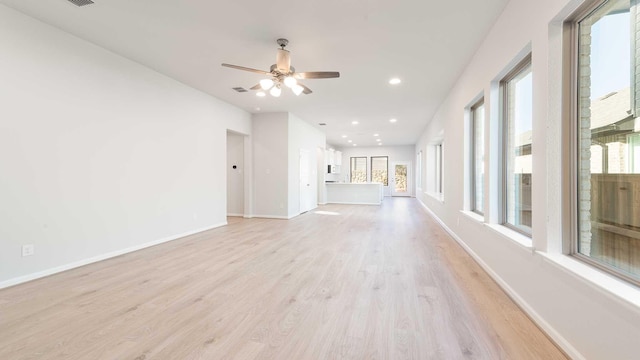 unfurnished living room with light hardwood / wood-style floors and ceiling fan