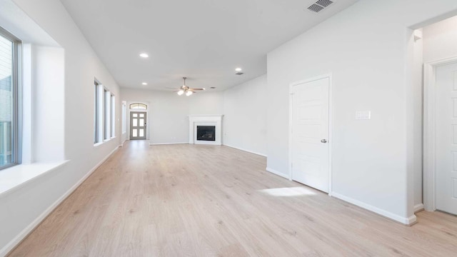 unfurnished living room featuring light hardwood / wood-style flooring and ceiling fan