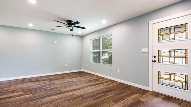 spare room featuring ceiling fan and dark hardwood / wood-style flooring