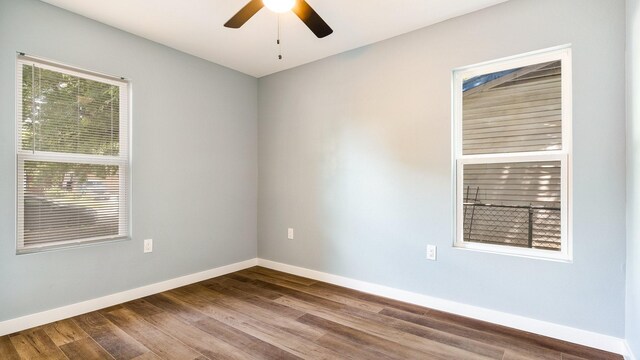 unfurnished room with hardwood / wood-style floors and ceiling fan