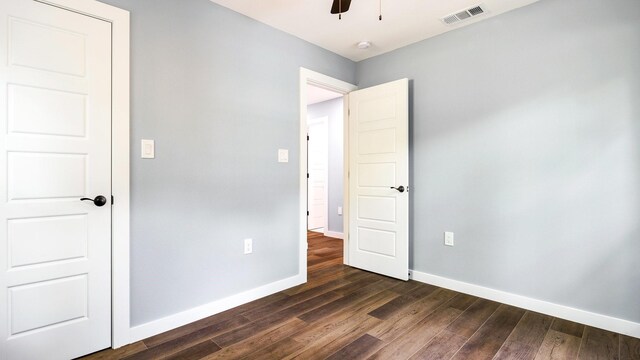 unfurnished bedroom featuring dark hardwood / wood-style floors and ceiling fan