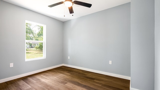 spare room featuring a wealth of natural light, ceiling fan, and hardwood / wood-style floors