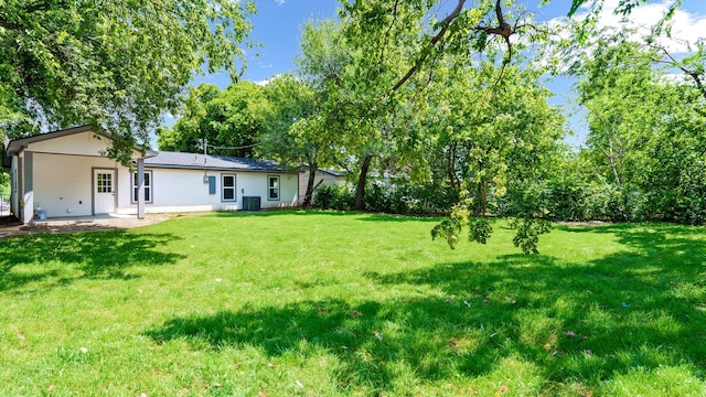 view of yard featuring a patio area and central AC unit