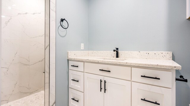 bathroom featuring vanity and a tile shower