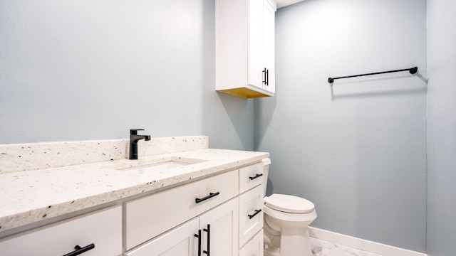 bathroom featuring tile patterned floors, vanity, and toilet