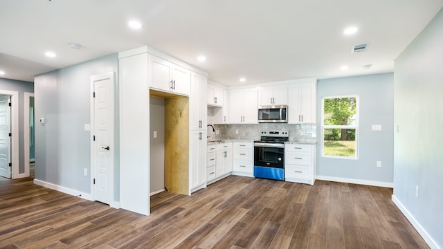 kitchen with white cabinets, stainless steel appliances, and dark hardwood / wood-style flooring