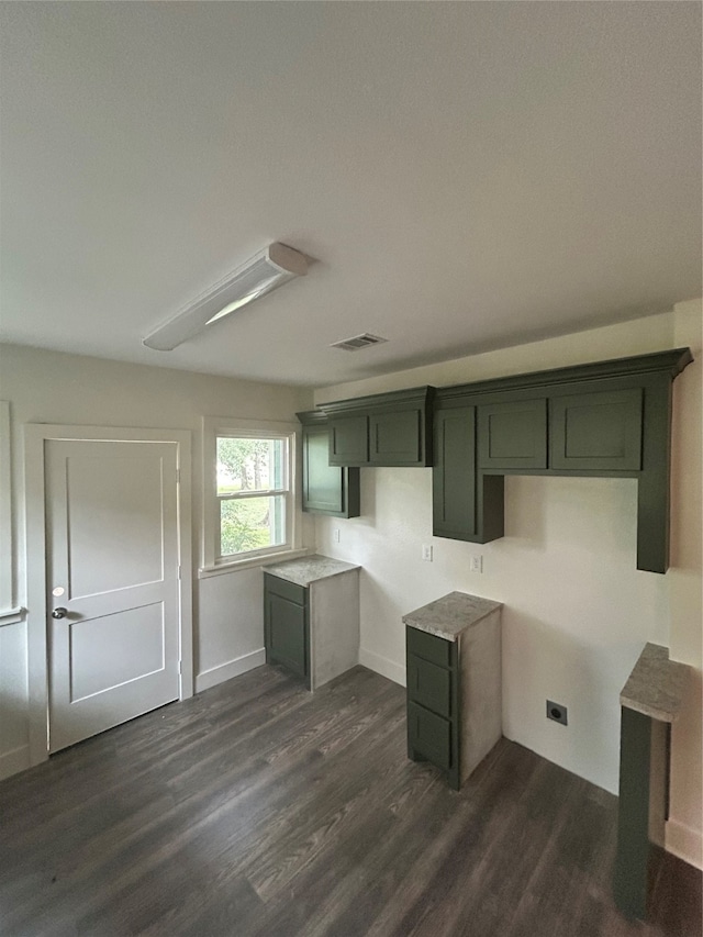 kitchen with dark hardwood / wood-style flooring and green cabinetry