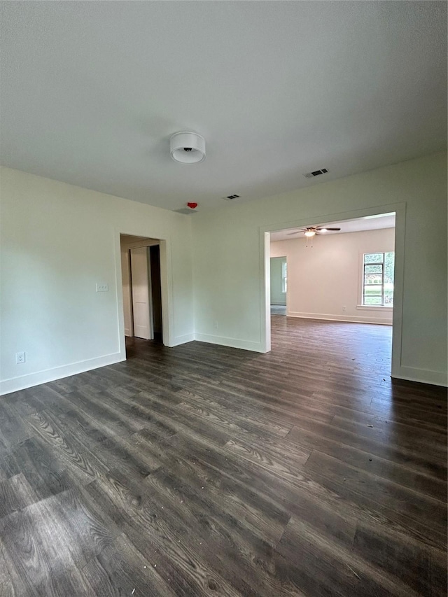 unfurnished room with ceiling fan and dark hardwood / wood-style flooring