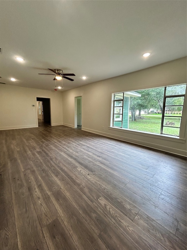 unfurnished room with plenty of natural light, hardwood / wood-style floors, and ceiling fan