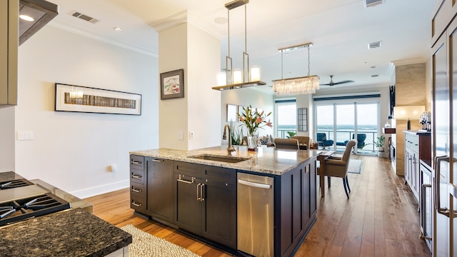 kitchen featuring sink, stone countertops, and light wood-type flooring