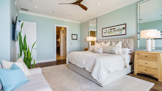 bedroom with ornamental molding, ceiling fan, and dark wood-type flooring