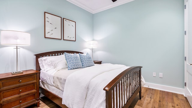 bedroom featuring hardwood / wood-style flooring and ornamental molding