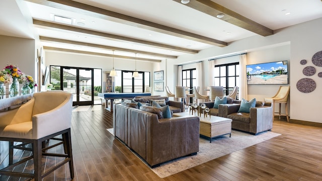 living room featuring beamed ceiling, french doors, hardwood / wood-style floors, and a wealth of natural light