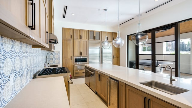 kitchen featuring light tile patterned flooring, oven, tasteful backsplash, and sink