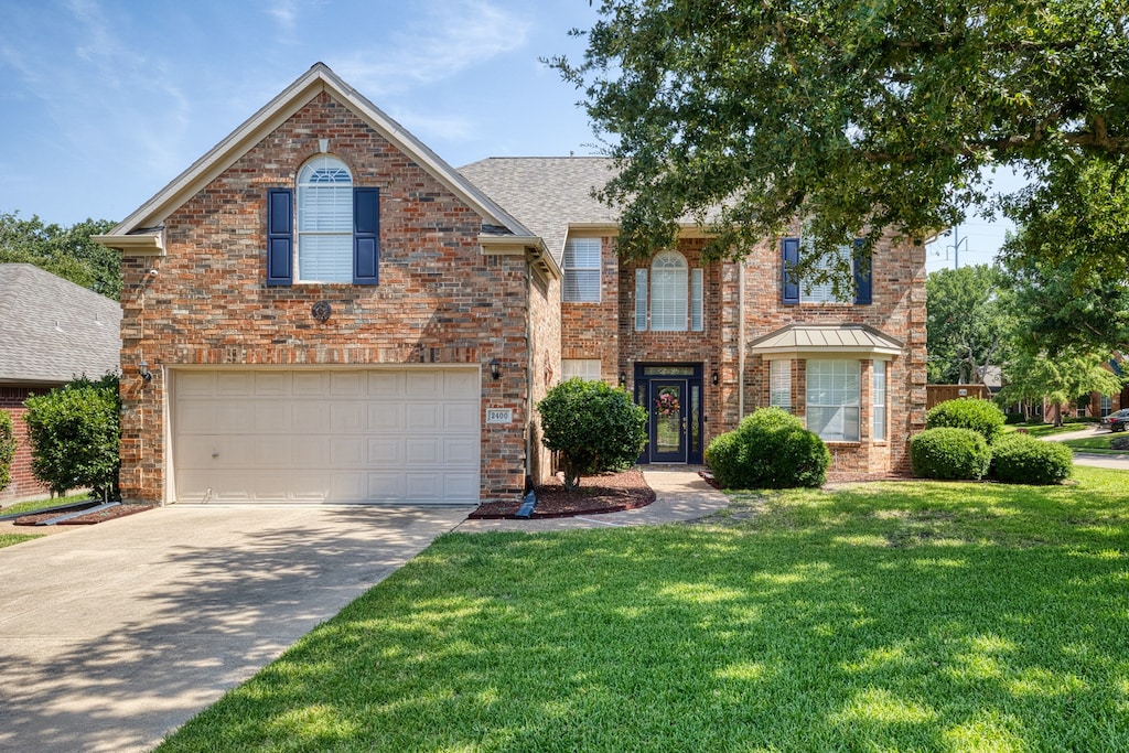 front facade featuring a front yard and a garage