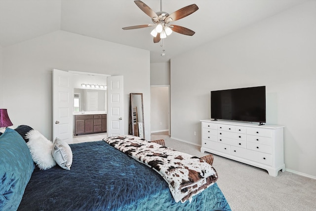 carpeted bedroom with ensuite bathroom, ceiling fan, and high vaulted ceiling