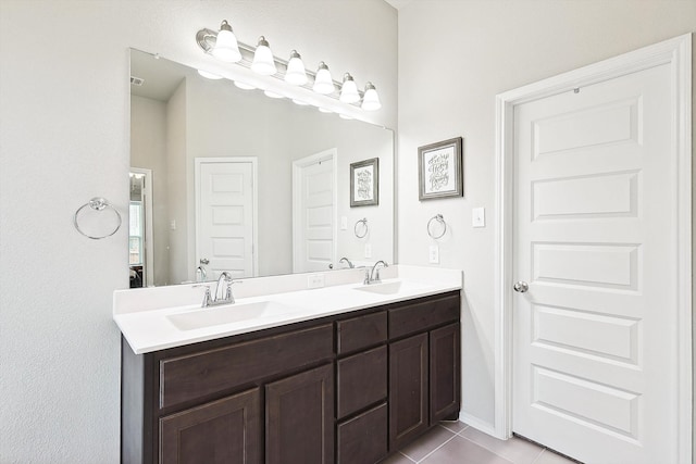 bathroom featuring double vanity and tile patterned flooring