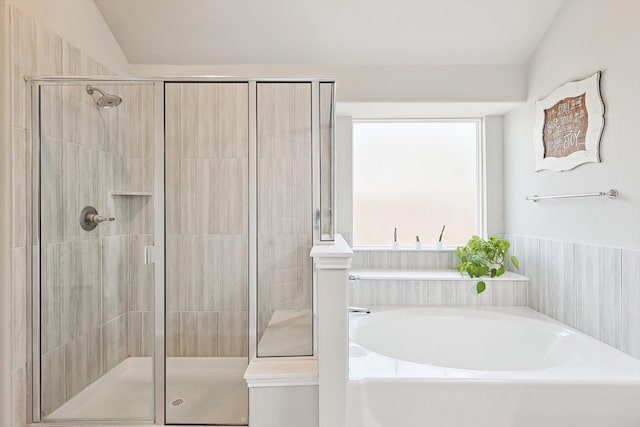 bathroom featuring shower with separate bathtub and lofted ceiling