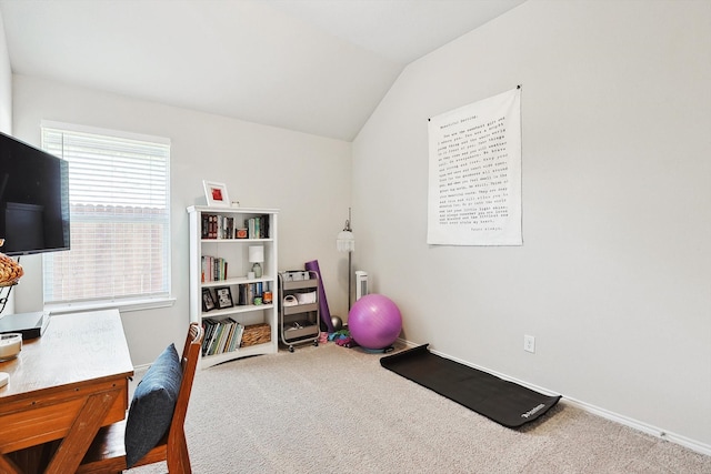 carpeted office space featuring vaulted ceiling