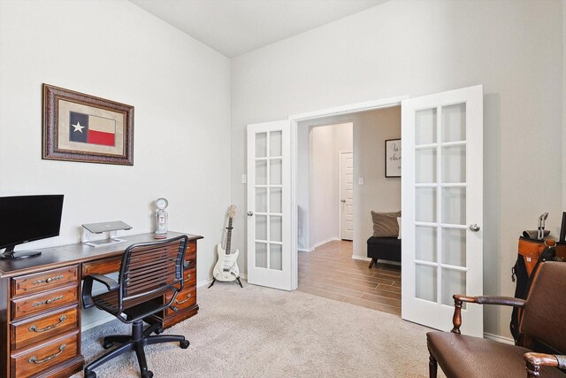 carpeted office featuring french doors