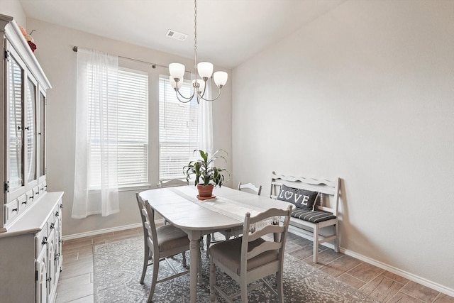 dining area with a wealth of natural light and a chandelier