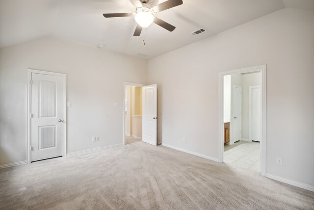 unfurnished bedroom featuring light carpet, vaulted ceiling, and ceiling fan