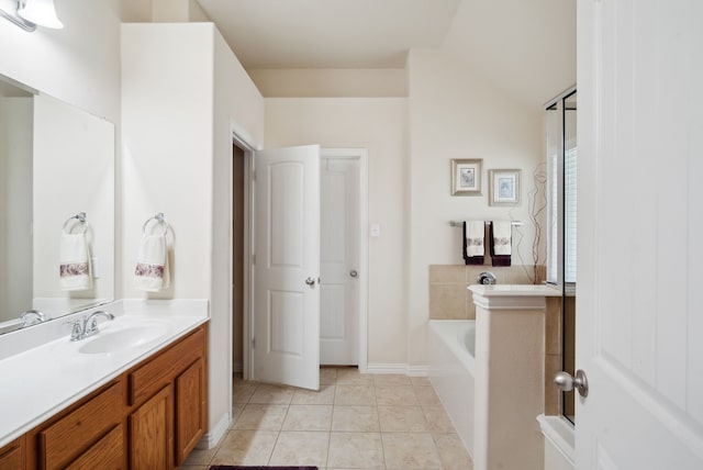 bathroom featuring lofted ceiling, a bath, tile patterned flooring, and vanity