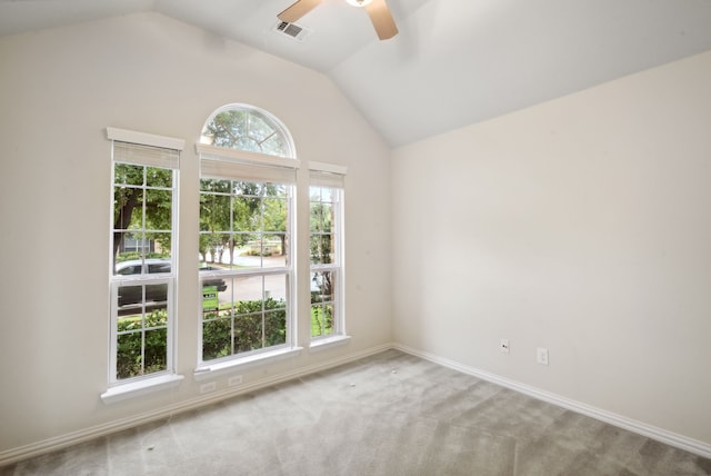 spare room with lofted ceiling, light carpet, and ceiling fan