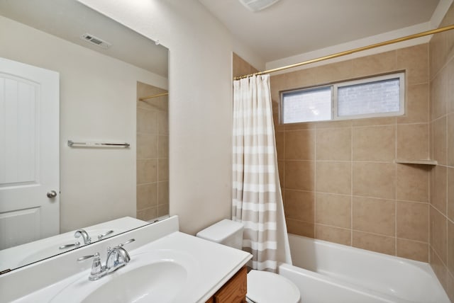 full bathroom with shower / bath combination with curtain, vanity, and toilet