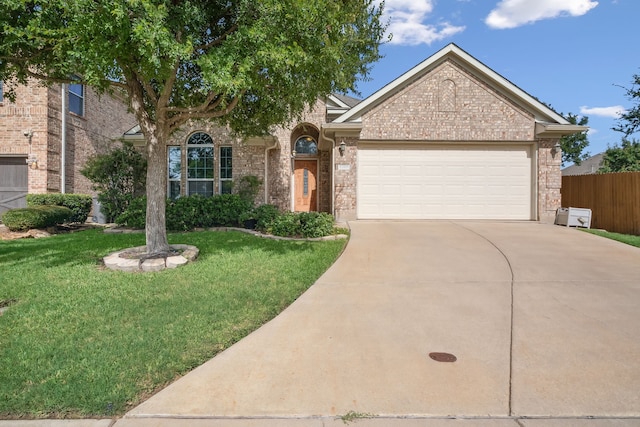 view of front of house with a front yard and a garage