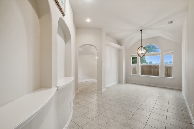 unfurnished room featuring lofted ceiling, a notable chandelier, and light tile patterned floors