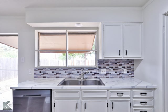 kitchen featuring sink, stainless steel dishwasher, a healthy amount of sunlight, and white cabinets