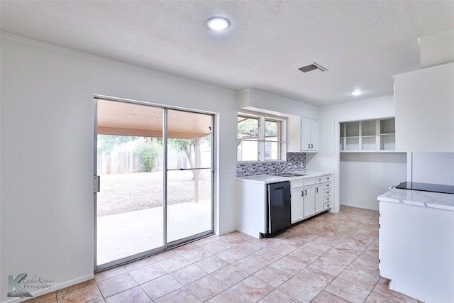 kitchen with white cabinetry, tasteful backsplash, light tile patterned floors, and black dishwasher