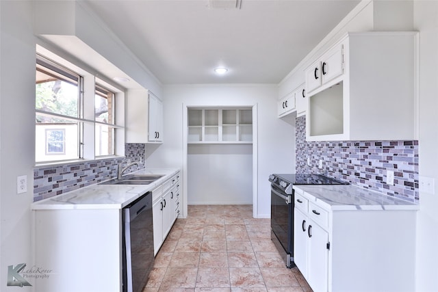 kitchen with tasteful backsplash, sink, light tile patterned floors, black electric range oven, and white cabinetry