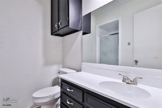 bathroom featuring toilet and vanity