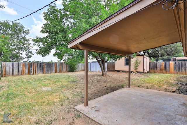 view of yard with a shed and a patio area