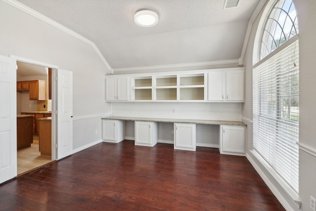 unfurnished office with crown molding, dark hardwood / wood-style floors, and built in desk