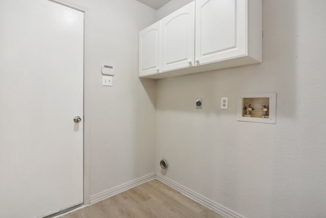 clothes washing area with hookup for an electric dryer, light hardwood / wood-style flooring, cabinets, and hookup for a washing machine