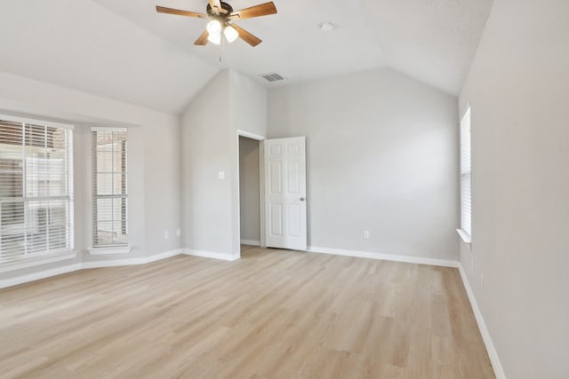 empty room featuring light wood-type flooring, ceiling fan, and lofted ceiling