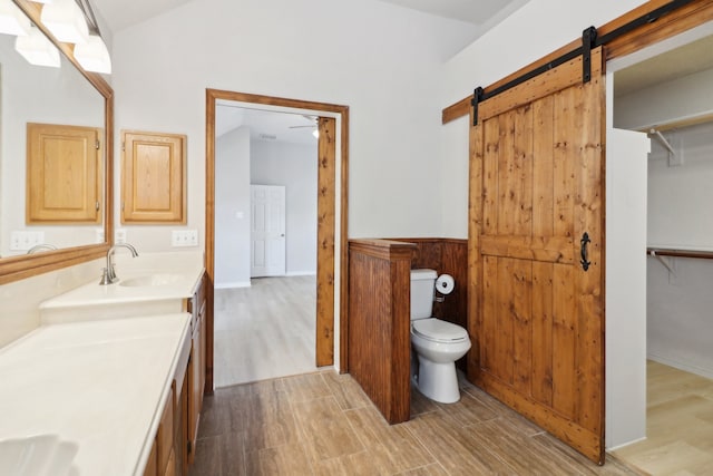 bathroom with hardwood / wood-style floors, toilet, and vanity